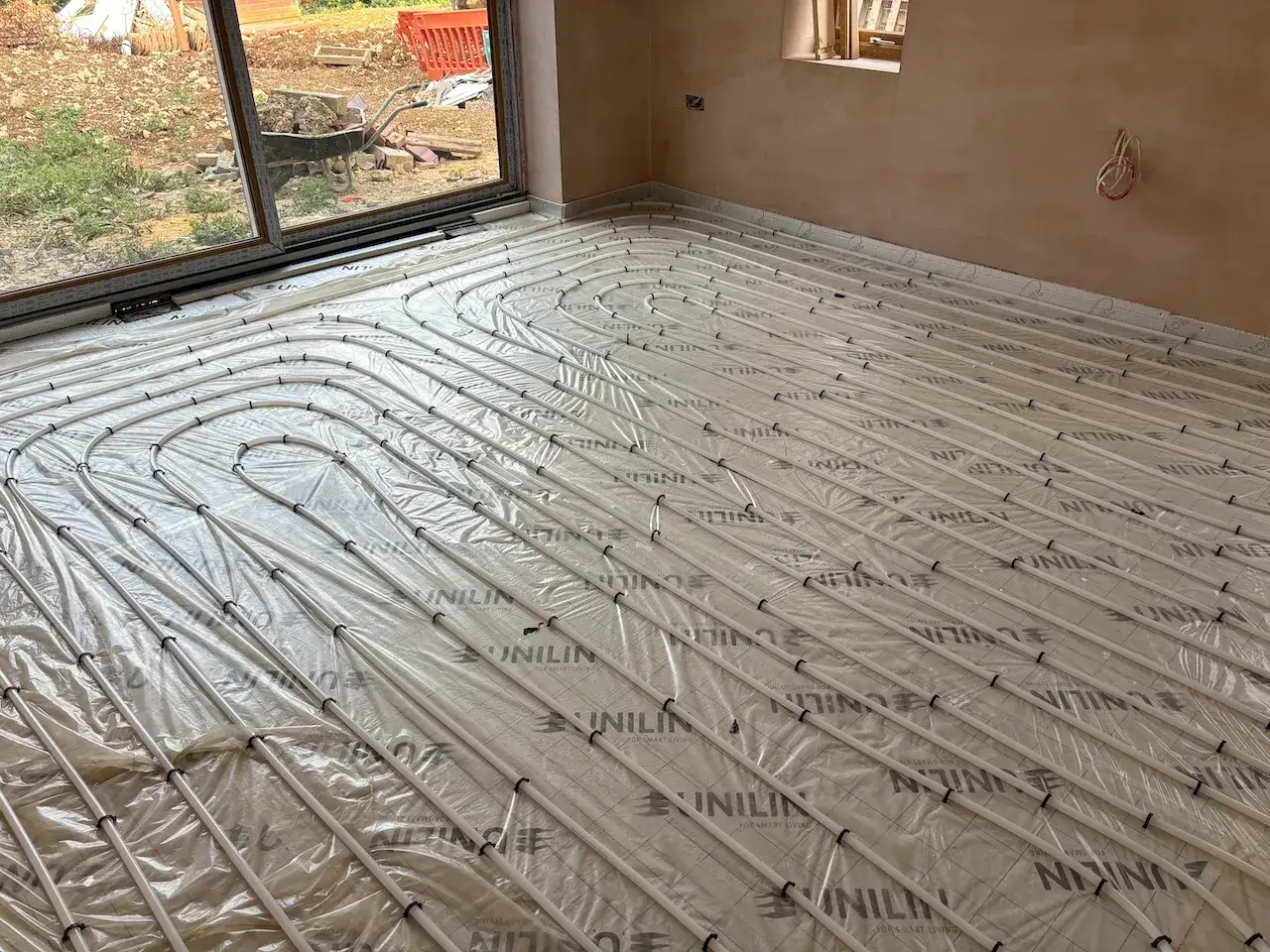 A room with a large sheet of insulation on the floor.