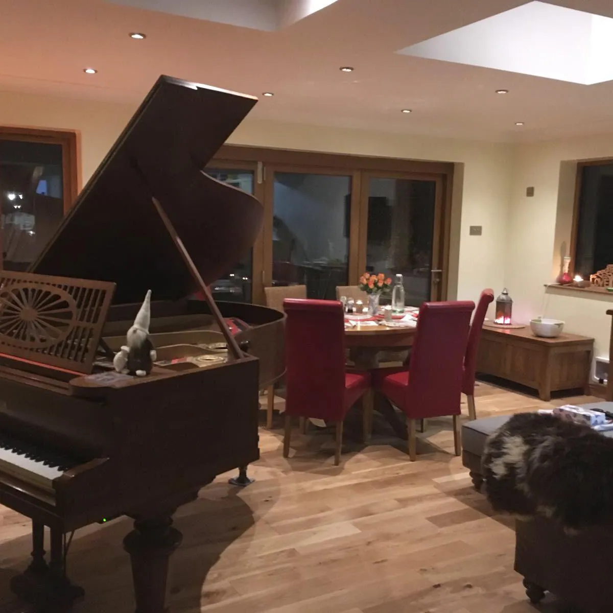 a living room filled with furniture and a grand piano